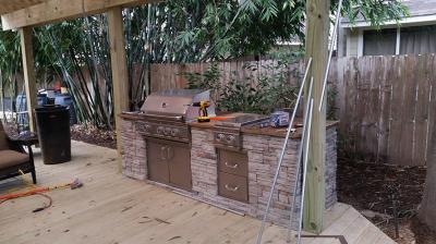 Outdoor kitchen with custom wood deck with shade arbor